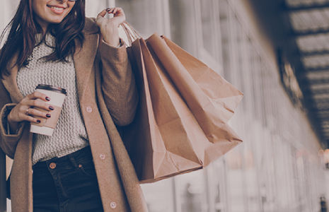 woman holding kraft paper shopping bags